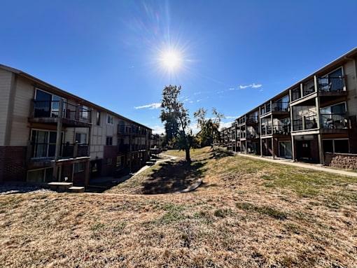 an exterior view of an apartment building on a sunny day