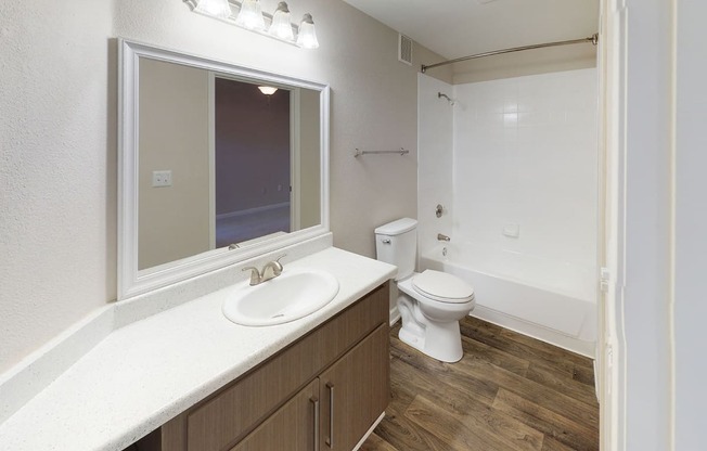 Full Bath with white countertops and updated modern lighting