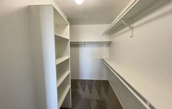 A long white hallway with a light on the ceiling.