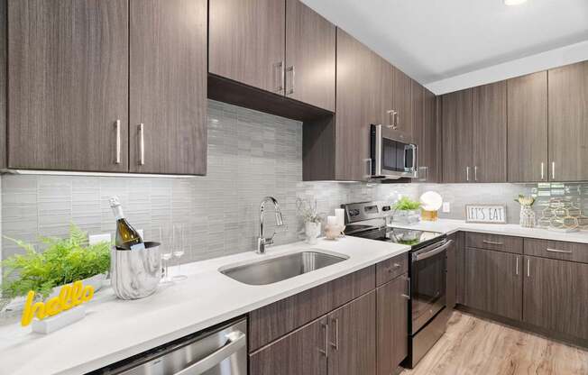 A kitchen with wooden cabinets and a white countertop.