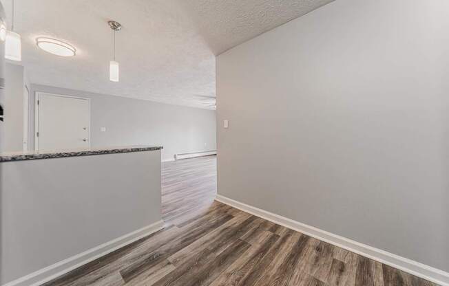 A room with a wooden floor and white walls.
