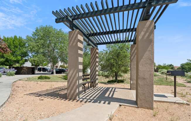 a shade structure on the side of a sidewalk