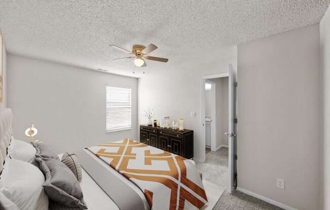 A bedroom with a bed, nightstand, and a ceiling fan.