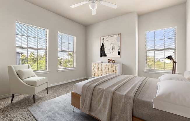 a bedroom with four windows and a ceiling fan