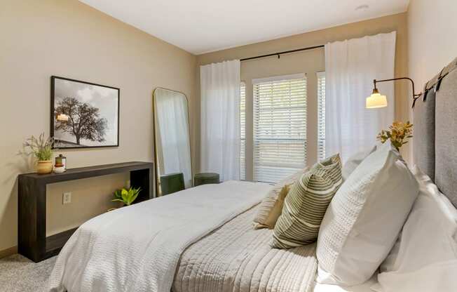 a bedroom with a large bed and a window at Summerwind, Pearland, 77584