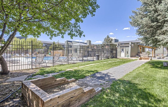 a park with a wooden bench and a fence