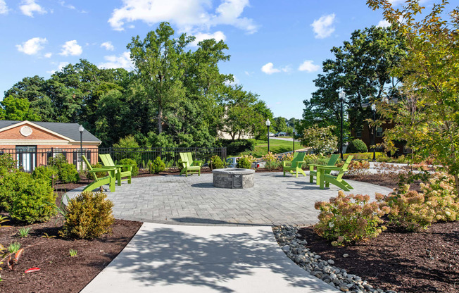 a patio with chairs and a fire pit