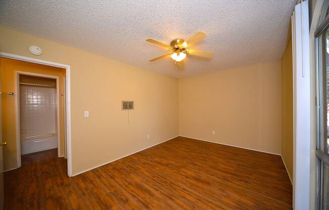 Ponderosa Apartments unfurnished bedroom with ceiling fan