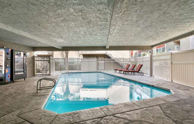 Apartments in Marina Del Rey CA - Sparkling Swimming Pool Surrounded by Lounge Chairs and Vending Machines