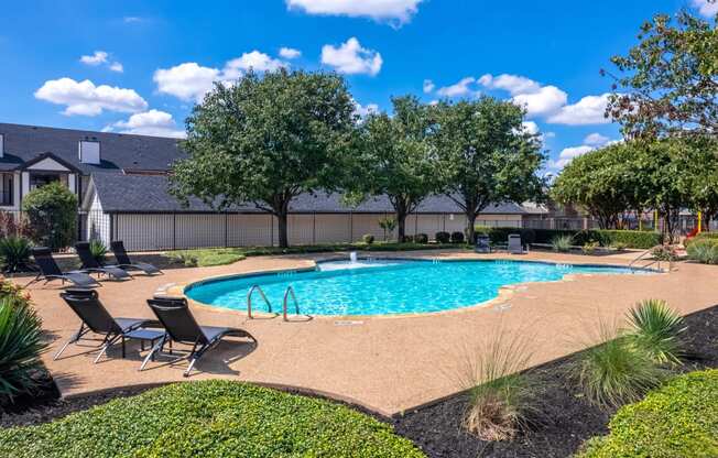 the preserve at ballantyne commons pool and patio with chairs and trees