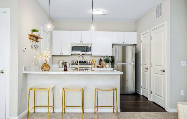 a kitchen with white cabinets and a white counter top