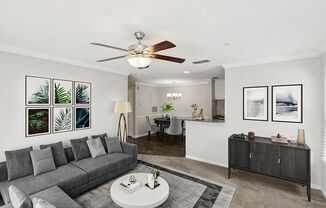 Model Living Room with Carpet and View of Dining Room with Wood-Style Flooring at Shadow Ridge Apartments in Riverdale, GA.