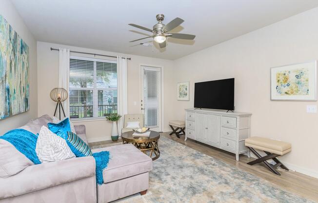 a living room filled with furniture and a large window
