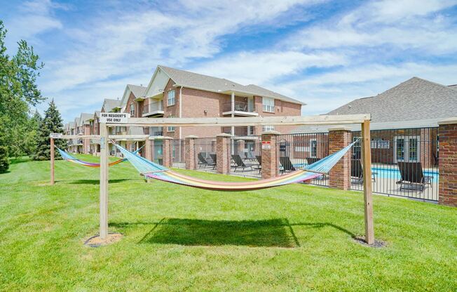 a pair of hammocks near the community clubhouse and pool