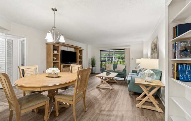 A well-lit, spacious dining room with a wooden table and chairs at Hampton Apartments, Clearwater 33759