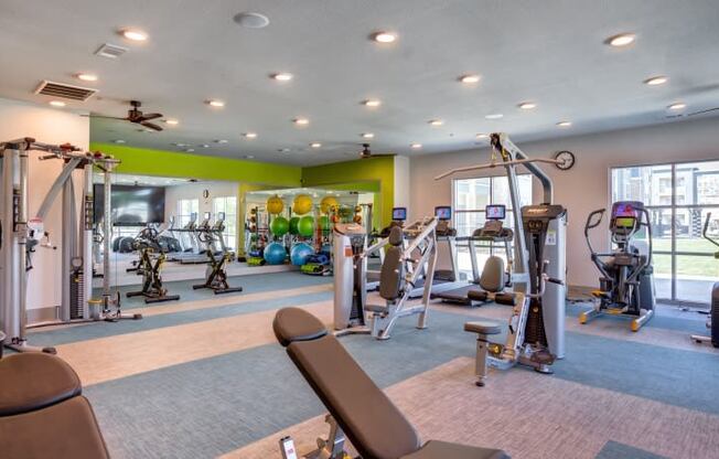 Georgetown Apartments for Rent - Williamson at the Overlook Fully Equipped Fitness Center with Large Windows, Ellipticals, Treadmill, and Various Cardio Equipment