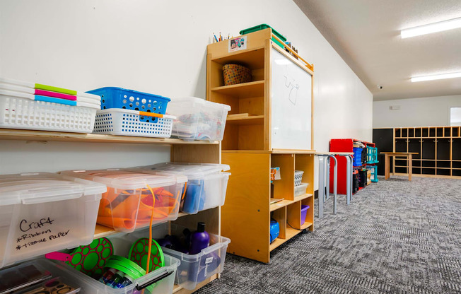 a classroom with shelves and bins and a whiteboard at Sutton Hill Apartments, IOWA, 50320