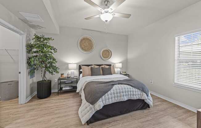 a bedroom with a bed and a ceiling fan