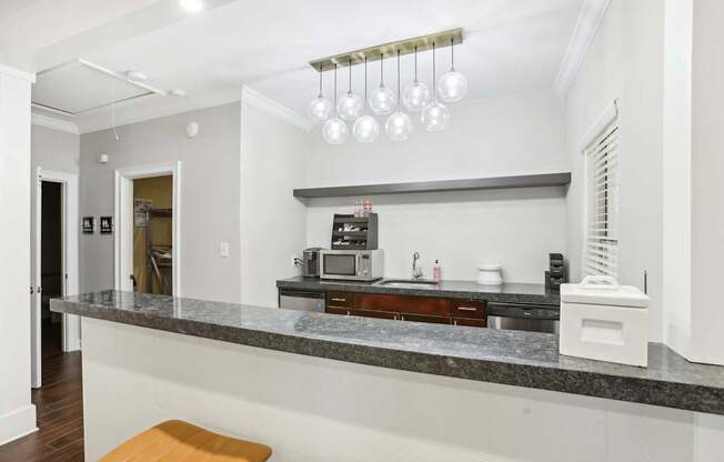 A kitchen with a marble countertop and a bench.