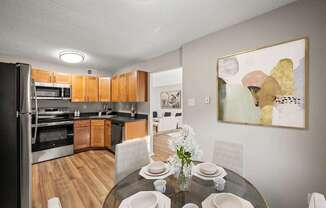 A modern kitchen with a dining table set for four.