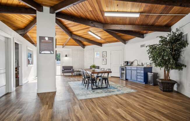 a living room with a wooden ceiling and a dining room table