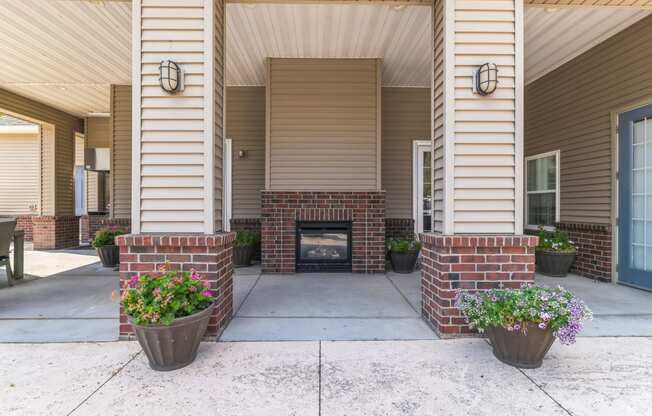 the view of the front porch of an apartment building with a fireplace