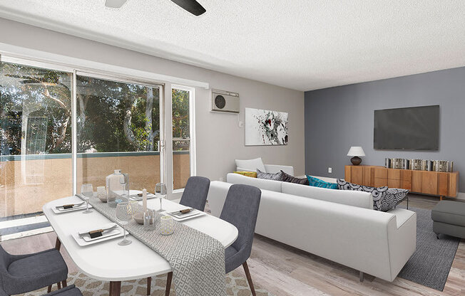 Hardwood floored dining room with ceiling fan and view of living room and private balcony.