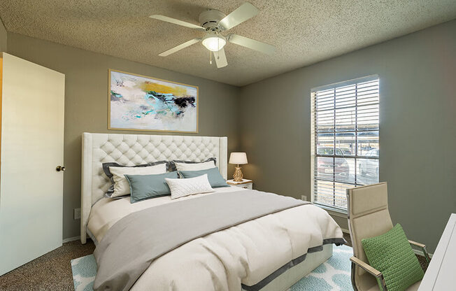 bedroom with overhead fan, light, and large window