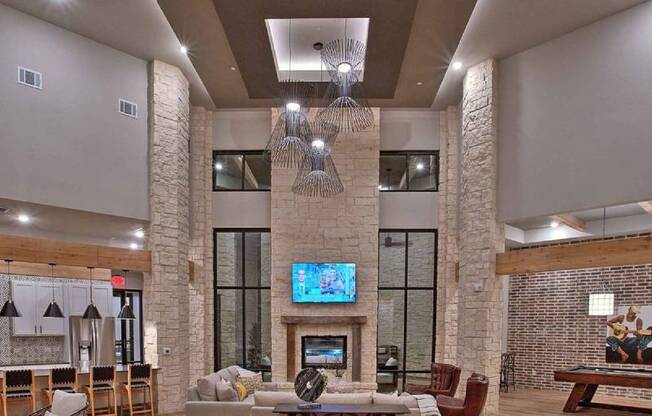 a living room with a fireplace and a television at Hunters Creek Apartments, Denton, TX