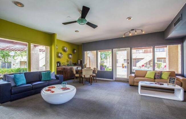 A living room with a blue couch and a white coffee table.