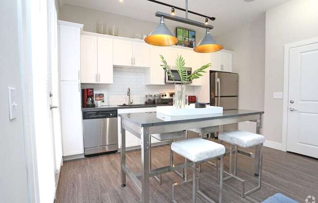 A modern kitchen with a stainless steel dishwasher and refrigerator.at Century Baxter Avenue, Louisville, KY 40204