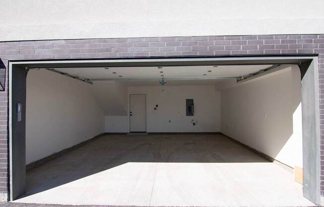 the inside of an empty garage with the door open