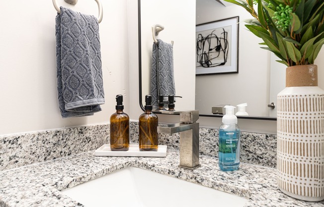 Bright bathroom with granite counters and high rise faucet