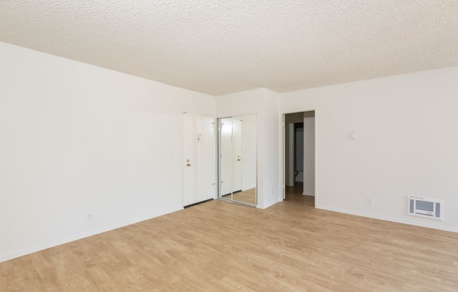 Living Room with Hardwood Floors and Mirrored Closet