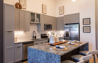 a kitchen with stainless steel appliances and a granite counter top