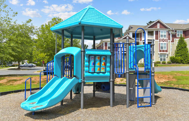 a playground with a swing set and a slide