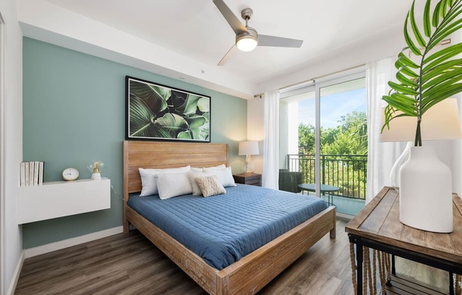 a bedroom with a bed and a ceiling fan