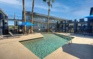 our apartments have a resort style pool with chairs and umbrellas