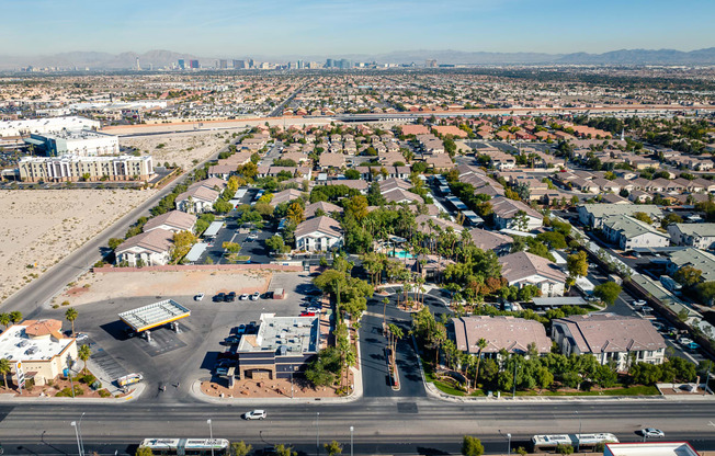 an aerial view of a neighborhood of houses and cars on a road