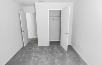 an empty room with white walls and a closet