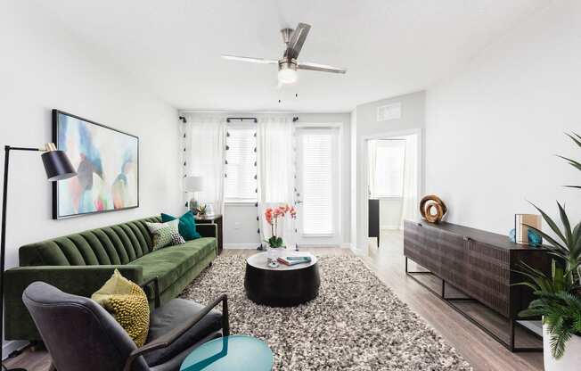 Spacious living room with large windows and natural lighting at Residences at The Green in Lakewood Ranch