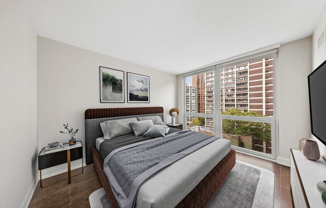 a bedroom with a large bed and a large window