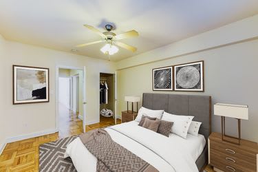 bedroom with bed, nightstands, hardwood flooring and ceiling fan at meridian park apartments in washington dc