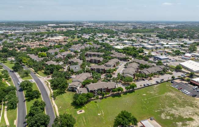 A bird's eye view of a residential area with houses and a road.