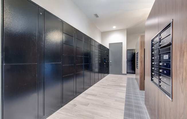 a long hallway with a long row of refrigerators in a large room with wood