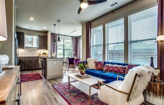 Grand Prairie TX Apartments - Living Room Area With Hardwood Style Floors, Chic Decor and Access to Kitchen & Dining Areas