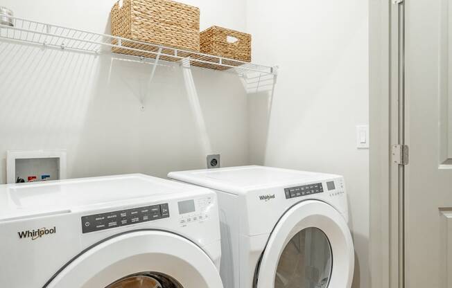 a front load washer and dryer in a laundry room at Anthem Apartments and Cottages in Huntsville, Alabama