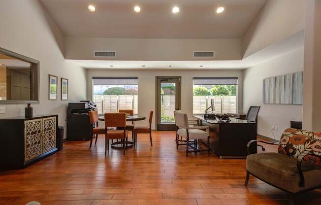 A living room with a brown wooden floor and furniture.