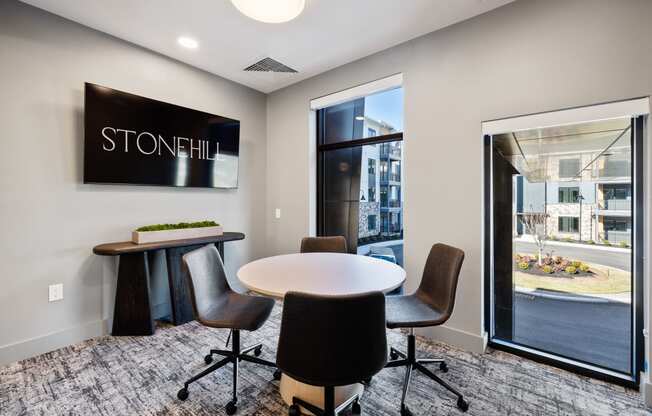 a conference room with a table and chairs in front of a window