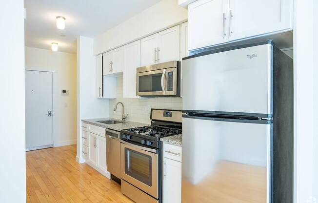 A kitchen with a black fridge and stove top oven at 603 Concord Apartments, Cambridge, Massachusetts